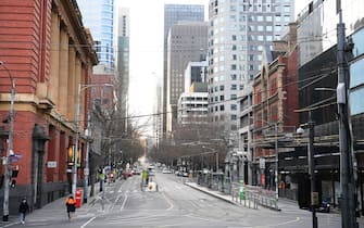 MELBOURNE, AUSTRALIA - AUGUST 11: A very quiet Bourke Street is seen on August 11, 2020 in Melbourne, Australia.  Metropolitan Melbourne  is under stage 4 lockdown restrictions, with people only allowed to leave home to give or receive care, shopping for food and essential items, daily exercise and work while an overnight curfew from 8pm to 5am is also in place. The majority of retail businesses are also closed. Other Victorian regions are in stage 3 lockdown. The restrictions, which came into effect from 2 August, have been introduced by the Victorian government as health authorities work to reduce community COVID-19 transmissions across the state. (Photo by Quinn Rooney/Getty Images)