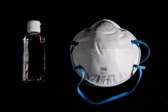 A picture taken on March 4, 2020, in Paris, shows a bottle of alcohol gel hand sanitiser and an FFP2 protective face mask. - Sales of face masks and hand sanitiser have risen and shortages are occuring in countries affected by the spread of COVID-19, the new coronavirus. (Photo by Olivier MORIN / AFP) (Photo by OLIVIER MORIN/AFP via Getty Images)