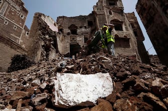 YEMEN FLOODS epa08599462 A Yemeni works on the site of rain-collapsed buildings in the old city of Sana a, Yemen, 12 August 2020. According to reports, torrential rains and flooding in Yemen have claimed the lives of at least 170 people, including 19 children, and destroyed hundreds of houses and roads across the war-torn Arab country over the past few weeks. EPA/YAHYA ARHAB EPA-EFE/YAHYA ARHAB