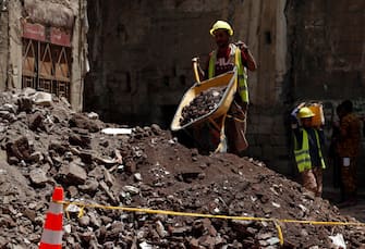 YEMEN FLOODS epa08599480 Yemenis work on the site of rain-collapsed buildings in the old city of Sana a, Yemen, 12 August 2020. According to reports, torrential rains and flooding in Yemen have claimed the lives of at least 170 people, including 19 children, and destroyed hundreds of houses and roads across the war-torn Arab country over the past few weeks. EPA/YAHYA ARHAB