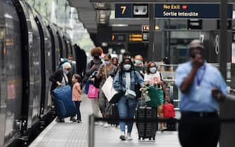 epa08605196 Travellers arrive back in the UK from Paris at St.Pancras International station in London, Britain, 15 August 2020. UK quarantine measures for France have come into force from 04.00 GMT 15 August. Those travellers who missed the deadline will have to quarantine for two weeks.  EPA/ANDY RAIN