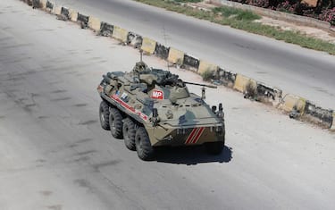 Russian armoured vehicles drive as part of a joint Turkish-Russian military patrol along the M4 highway, which links the northern Syrian provinces of Aleppo and Latakia, near Ariha in Syria's rebel-held northwestern Idlib province, on June 10, 2020. (Photo by OMAR HAJ KADOUR / AFP) (Photo by OMAR HAJ KADOUR/AFP via Getty Images)