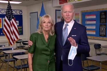 MILWAUKEE, WI - AUGUST 18: In this screenshot from the DNCCâ  s livestream of the 2020 Democratic National Convention, Presumptive Democratic presidential nominee former Vice President Joe Biden holds a mask in his hand as he joins Former U.S. Second Lady Dr. Jill Biden in a classroom after she addressed the virtual convention on August 18, 2020.  The convention, which was once expected to draw 50,000 people to Milwaukee, Wisconsin, is now taking place virtually due to the coronavirus pandemic.  (Photo by DNCC via Getty Images)  (Photo by Handout/DNCC via Getty Images)