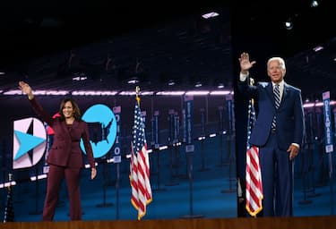 Senator from California and Democratic vice presidential nominee Kamala Harris and Former vice-president and Democratic presidential nominee Joe Biden wave from the stage socially distanced from each other at the end of the third day of the Democratic National Convention, being held virtually amid the novel coronavirus pandemic, at the Chase Center in Wilmington, Delaware on August 19, 2020. (Photo by Olivier DOULIERY / AFP) (Photo by OLIVIER DOULIERY/AFP via Getty Images)