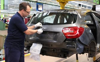 (FILES) - Photo taken on July 16, 2012 shows an employee assembling the Mercedes-Benz logo on one of the new Mercedes-Benz A class car at German auto giant Daimler's plant in Rastatt, southern Germany. Daimler will present its 2012 second quarter results on July 25, 2012. New car sales in Germany, a key gauge of demand in one of the most important sectors of Europe's biggest economy, are continuing to defy the crisis and still on the rise, data of the VDA industry federation showed on July 3, 2012.  AFP PHOTO / DANIEL ROLAND        (Photo credit should read DANIEL ROLAND/AFP/GettyImages)