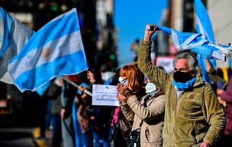 People wave Argentine flags during a protest against the government health policies, regarding the tight lockdown measures against the spread of the novel COVID-19 coronavirus, at 9 de Julio avenue, in Buenos Aires, Argentina, on August 17, 2020. (Photo by RONALDO SCHEMIDT / AFP) (Photo by RONALDO SCHEMIDT/AFP via Getty Images)