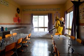 A Federal District's employee disinfects a public school as a measure against the spread of the new coronavirus in Brasilia, on August 5, 2020. - The local government has begun preparations for the safe reopening of schools in early September, as restrictions related to the COVID-19 lockdown are eased. (Photo by EVARISTO SA / AFP) (Photo by EVARISTO SA/AFP via Getty Images)