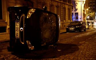 A picture taken on August 23, 2020 shows a turned-over car near the Champs-Elysees in Paris, as PSG supporters gather after the UEFA Champions League final football match between Paris Saint-Germain and Bayern Munich at the Luz stadium in Lisbon. - Bayern Munich won the Champions League on August 23, 2020 after a 1-0 victory over Paris Saint-Germain saw the German giants crowned Europe's top team for the sixth time. Kingsley Coman's 59th-minute header ensured Bayern triumphed at the Estadio da Luz in Lisbon and condemned his boyhood club PSG to defeat in their first ever final in the competition (Photo by Sameer Al-DOUMY / AFP) (Photo by SAMEER AL-DOUMY/AFP via Getty Images)