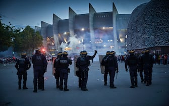 PARIS, FRANCE - AUGUST 23: French Riot police face Paris Saint Germain Fans during violent confrontation outside PSG's Parc de Princes Stadium as the Champions League Final was being played on August 23, 2020 in Paris, France. Paris Saint German football team have reached the 2019/20 UEFA Champions League finals for the first time in their history, just eleven days after celebrating their 50th Anniversary, taking on five-time winners Bayern Munich at the Estádio da Luz in Lisbon. (Photo by Kiran Ridley/Getty Images)