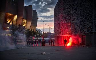 PARIS, FRANCE - AUGUST 23: A flare lands near French Riot Police outside PSG's Parc de Princes Stadium during violent confrontations between police and fans as the Champions League Final was being played on August 23, 2020 in Paris, France. Paris Saint German football team have reached the 2019/20 UEFA Champions League finals for the first time in their history, just eleven days after celebrating their 50th Anniversary, taking on five-time winners Bayern Munich at the Estádio da Luz in Lisbon. (Photo by Kiran Ridley/Getty Images)