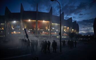 PARIS, FRANCE - AUGUST 23: French Riot Police stand in clouds of tear gas outside PSG's Parc de Princes Stadium during violent confrontations between police and fans during the Champions League Final on August 23, 2020 in Paris, France. Paris Saint German football team have reached the 2019/20 UEFA Champions League finals for the first time in their history, just eleven days after celebrating their 50th Anniversary, taking on five-time winners Bayern Munich at the Estádio da Luz in Lisbon. (Photo by Kiran Ridley/Getty Images)