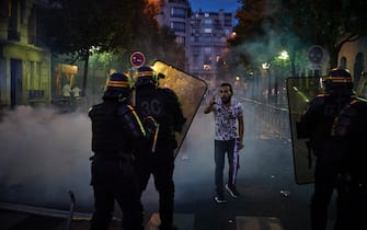 PARIS, FRANCE - AUGUST 23: A Paris Saint Germain fan taunts French Riot Police outside PSG's Parc de Princes Stadium during violent confrontations between police and fans as the Champions League Final was being played on August 23, 2020 in Paris, France. Paris Saint German football team have reached the 2019/20 UEFA Champions League finals for the first time in their history, just eleven days after celebrating their 50th Anniversary, taking on five-time winners Bayern Munich at the Estádio da Luz in Lisbon. (Photo by Kiran Ridley/Getty Images)