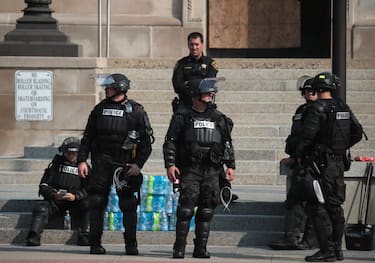 KENOSHA, WISCONSIN - AUGUST 24: Police gather in front of the Kenosha County Court House after a night of unrest, on August 24, 2020 in Kenosha, Wisconsin. The unrest stemmedÂ from an incident in whichÂ police shot a Black man multiple times in the back as he entered the driver's side door of a vehicle. (Photo by Scott Olson/Getty Images)