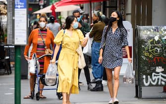 NEW YORK, NEW YORK - AUGUST 29: People wear protective face masks in Korea Town as the city continues Phase 4 of re-opening following restrictions imposed to slow the spread of coronavirus on August 29, 2020 in New York City. The fourth phase allows outdoor arts and entertainment, sporting events without fans and media production. (Photo by Noam Galai/Getty Images)