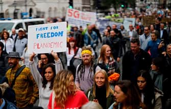 Protesters march down Whitehall in central London to "expose the truth about Covid and lockdown" at a demonstration organised by Save our Rights on August 29, 2020. (Photo by Tolga Akmen / AFP) (Photo by TOLGA AKMEN/AFP via Getty Images)