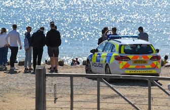 BURTON BRADSTOCK, UNITED KINGDOM - AUGUST 29: Police at the scene of the 9,000 ton cliff fall on August 29, 2020 in Burton Bradstock, Dorset, England. The fall happened at Hive Beach near the village of Burton Bradstock shortly before 06:30 BST, Dorset Council said. Fire crews using thermal imaging equipment were called in to check for any trapped casualties but nothing was found. The council described it as a "huge" rock fall and said recent heavy rain had made cliffs unstable. (Photo by Finnbarr Webster/Getty Images)