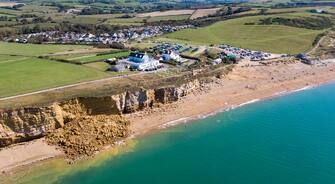 BURTON BRADSTOCK, DORSET - AUGUST 30: Aerial view of the 9,000 ton cliff fall on August 30, 2020 in Burton Bradstock, Dorset. The fall happened at Hive Beach near the village of Burton Bradstock, Dorset Council said. Fire crews using thermal imaging equipment were called in to check for any trapped casualties but nothing was found. The council described it as a "huge" rock fall and said recent heavy rain had made cliffs unstable. (Photo by Finnbarr Webster/Getty Images)