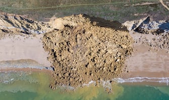BURTON BRADSTOCK, DORSET - AUGUST 30: Aerial view of the 9,000 ton cliff fall on August 30, 2020 in Burton Bradstock, Dorset. The fall happened at Hive Beach near the village of Burton Bradstock, Dorset Council said. Fire crews using thermal imaging equipment were called in to check for any trapped casualties but nothing was found. The council described it as a "huge" rock fall and said recent heavy rain had made cliffs unstable. (Photo by Finnbarr Webster/Getty Images)