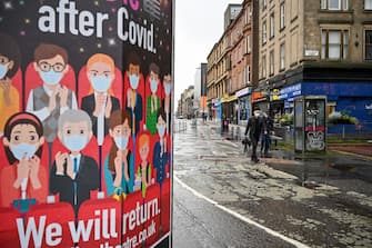 GLASGOW, SCOTLAND - SEPTEMBER 02: Members of the public walk past coronavirus posters on September 02, 2020 in Glasgow, Scotland. Starting last night, Scottish authorities banned people in Glasgow city, West Dunbartonshire and East Renfrewshire from visiting other households. The new rules, which last for two weeks, come as 135 new coronavirus cases were reported in the Greater Glasgow and Clyde area in the last two days. (Photo by Jeff J Mitchell/Getty Images)