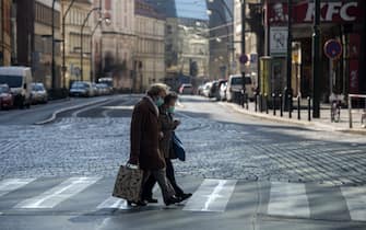 Erderly women wearing face masks walk across the street on March 18, 2020, in Prague, where activities came to a halt due to the spread of the novel coronavirus COVID-19. - The Czech Republic, a European Union country of 10.7 million people, has registered 464 confirmed cases of the virus, including three cured patients, and no deaths. (Photo by Michal Cizek / AFP) (Photo by MICHAL CIZEK/AFP via Getty Images)
