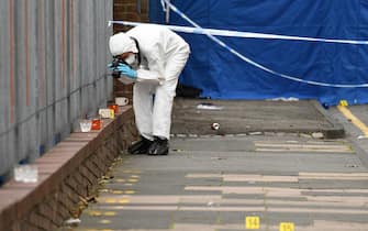 A police forensics officer takes photographs as he gathers evidence inside a cordon on Irving Street, following a major stabbing incident in the centre of Birmingham, central England, on September 6, 2020. - British police declared a "major incident" early on September 6 after multiple people were stabbed in the centre of England's second city Birmingham. Violence broke out at about 12:30 am (2330 GMT Saturday) in and around the Arcadian Centre, a popular venue filled with restaurants, nightclubs and bars. (Photo by Oli SCARFF / AFP) (Photo by OLI SCARFF/AFP via Getty Images)