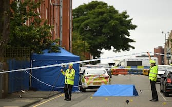 Police gather evidence near to forensics tents and evidence markers inside a cordon on Irving Street, following a major stabbing incident in the centre of Birmingham, central England, on September 6, 2020. - British police declared a "major incident" early on September 6 after multiple people were stabbed in the centre of England's second city Birmingham. Violence broke out at about 12:30 am (2330 GMT Saturday) in and around the Arcadian Centre, a popular venue filled with restaurants, nightclubs and bars. (Photo by Oli SCARFF / AFP) (Photo by OLI SCARFF/AFP via Getty Images)