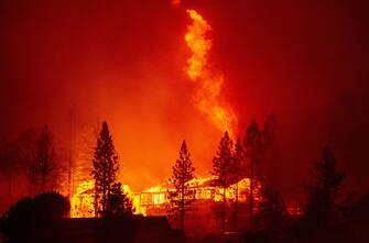 A home is engulfed in flames during the "Creek Fire" in the Tollhouse area of unincorporated Fresno County, California early on September 8, 2020. - Wildfires in California have torched a record more than two million acres, the state fire department said on September 7, as smoke hampered efforts to airlift dozens of people trapped by an uncontrolled blaze. (Photo by JOSH EDELSON / AFP) (Photo by JOSH EDELSON/AFP via Getty Images)
