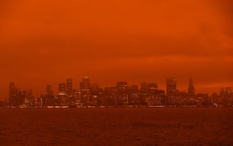 SAN FRANCISCO, CA - SEPTEMBER 09: Smoke from various wildfires burning across Northern California mixes with the marine layer, blanketing the San Francisco skyline in darkness and an orange glow, seen from Treasure Island on September 9, 2020 in San Francisco, California.  Over 2 million acres have burned this year as wildfires continue to burn across the state. (Photo by Philip Pacheco/Getty Images)