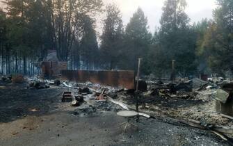 A burned out house is seen after the passing of the Holiday Farm fire in McKenzie Bridge, Oregon on September 9, 2020. - Hundreds of homes including entire communities were razed by wildfires in the western United States on September 9 as officials warned of potential mass deaths under apocalyptic orange skies. At least five towns were "substantially destroyed" in Oregon as widespread evacuations took place across the northwestern state, governor Kate Brown said. (Photo by Tyee BURWELL / AFP) (Photo by TYEE BURWELL/AFP via Getty Images)