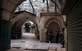 Israeli policemen wearing protective masks due to the COVID-19 pandemic, monitor a street lined with closed shops in Jerusalem's old city, on September 19, 2020, amid lockdown due to a spike in infection cases. - Israel imposed a second nationwide lockdown to tackle one of the world's highest coronavirus infection rates, despite public protests over the new blow to the economy. The three-week shutdown from yesterday just hours before Rosh Hashana, the Jewish New Year, and will extend through other key religious holidays, including Yom Kippur and Sukkot. (Photo by MENAHEM KAHANA / AFP) (Photo by MENAHEM KAHANA/AFP via Getty Images)