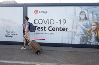 Illustration picture shows a traveller holding his suitcase as he leaves the Covid-19 test centre at Brussels Airport, Monday 14 September 2020 in Zaventem. BELGA PHOTO THIERRY ROGE (Photo by THIERRY ROGE/BELGA MAG/AFP via Getty Images)