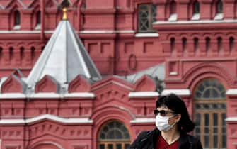 A woman wearing a face mask to protect against the coronavirus disease walks in downtown Moscow on September 17, 2020. (Photo by Yuri KADOBNOV / AFP) (Photo by YURI KADOBNOV/AFP via Getty Images)