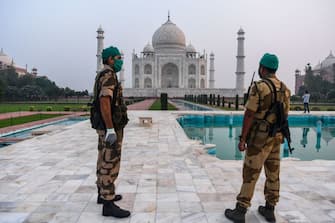 Security personnel stand guard at the Taj Mahal in Agra on September 21, 2020. - The Taj Mahal reopened to visitors on September 21 in a symbolic business-as-usual gesture even as India looks set to overtake the US as the global leader in coronavirus infections. (Photo by Sajjad HUSSAIN / AFP) (Photo by SAJJAD HUSSAIN/AFP via Getty Images)