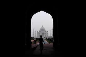 A worker cleans a pathway at the Taj Mahal in Agra on September 21, 2020. - The Taj Mahal reopened to visitors on September 21 in a symbolic business-as-usual gesture even as India looks set to overtake the US as the global leader in coronavirus infections. (Photo by Sajjad HUSSAIN / AFP) (Photo by SAJJAD HUSSAIN/AFP via Getty Images)
