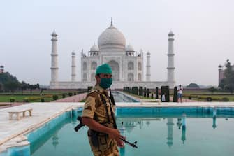 A security personnel patrols at the Taj Mahal in Agra on September 21, 2020. - The Taj Mahal reopened to visitors on September 21 in a symbolic business-as-usual gesture even as India looks set to overtake the US as the global leader in coronavirus infections. (Photo by Sajjad HUSSAIN / AFP) (Photo by SAJJAD HUSSAIN/AFP via Getty Images)