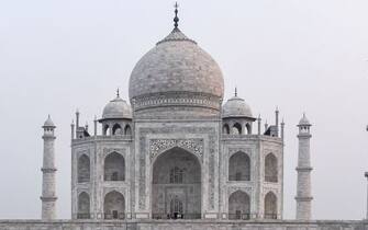 1228628329 A tourist has her picture taken at the Taj Mahal in Agra on September 21, 2020. - The Taj Mahal reopened to visitors on September 21 in a symbolic business-as-usual gesture even as India looks set to overtake the US as the global leader in coronavirus infections. (Photo by Sajjad HUSSAIN / AFP) (Photo by SAJJAD HUSSAIN/AFP via Getty Images)