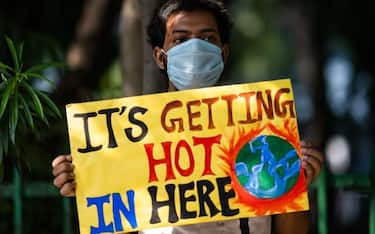 A participant displays a placard during a demonstration as a part of the "Fridays for Future" movement in New Delhi on September 25, 2020. (Photo by Jewel SAMAD / AFP) (Photo by JEWEL SAMAD/AFP via Getty Images)