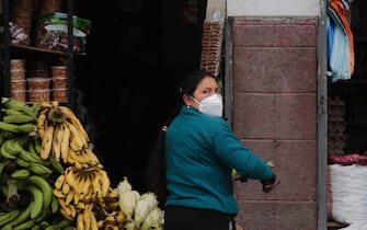 QUITO, ECUADOR - SEPTEMBER 01: A woman strips a corn husk on September 1, 2020 in Quito, Ecuador. Ecuador counts over 114,000 positive cases and more than 6,500 deaths. (Photo by Franklin Jacome/Agencia Press South/Getty Images)