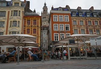 People sit at a cafe's terrace on September 9, 2020 in Lille, northern France. - From this Monday evening and for a fortnight, restaurants, night grocery stores, and bars will close at 12:30 a.m. every day in Lille to prevent the spread of the covid-19 pandemic caused  by the novel coronavirus. (Photo by DENIS CHARLET / AFP) (Photo by DENIS CHARLET/AFP via Getty Images)