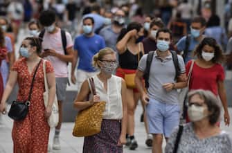 People with protective mask walk on a pedestrian street in Lyon on August 22, 2020 on the first day of mandatory mask wearing in parts of city centre. - Masks are obligatory to curb the spread of COVID-19 disease caused by the novel coronavirus in France in open areas of some cities as well as on public transport and in enclosed spaces such as shops, banks and government offices. (Photo by PHILIPPE DESMAZES / AFP) (Photo by PHILIPPE DESMAZES/AFP via Getty Images)