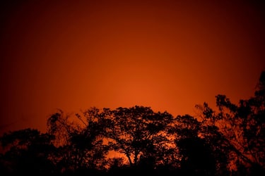 Red glow from the fire is seen at the wetland of Pantanal at the Transpantaneira park road in Mato Grosso state, Brazil, on September 13, 2020. - Pantanal is suffering its worst fires in more than 47 years, destroying vast areas of vegetation and causing death of animals caught in the fire or smoke. (Photo by Mauro Pimentel / AFP) (Photo by MAURO PIMENTEL/AFP via Getty Images)