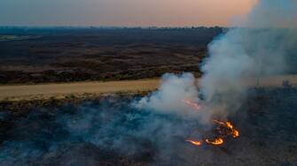 POCONE, BRAZIL - SEPTEMBER 25: An aerial view of a fire burning next to the Transpantaneira, a road that crosses the Pantanal on September 25, 2020 in Pocone, Brazil. Pantanal is located mostly within the Brazilian state of Mato Grosso and Mato Grosso do Sul and is the world's largest tropical wetland area, and the world's largest flooded grasslands. The region is considered by UNESCO as a World Natural Heritage and Biosphere Reserve. Since the beginning of September, more than 5,000 fires have been registered. The main cause of the induced fires is the livestock activity to transform the region into pastures. The biome has been going through four months of drought, which makes fire control difficult. The situation severely affects the local fauna and flora, which consists of thousands of species, some even endangered. (Photo by Buda Mendes/Getty Images)