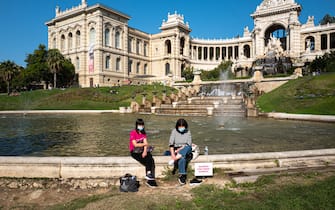 MARSEILLE, FRANCE - SEPTEMBER 30: Two women sitting around the fountain of the Longchamp Palace on September 30, 2020 in Marseille, France. The port city of Marseille has ordered all bars and restaurants to close for two weeks as part of local measures to limit the spread of COVID-19. France is considered one of the worst affected countries by the coronavirus pandemic in Europe with 542,639 reported cases and 31,808 deaths. (Photo by Jeremy Suyker/Getty Images)