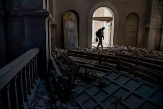 TOPSHOT - A man walks in rubbles on October 8, 2020 inside the Ghazanchetsots (Holy Saviour) Cathedral in the historic city of Shusha, some 15 kilometers from the disputed Nagorno-Karabakh province's capital Stepanakert, that was hit by a bomb as fighting between Armenian and Azerbaijani forces spilled over today ahead of a first meeting of international mediators in Geneva. - Nagorno-Karabakh broke away from Azerbaijan in a 1990s war that claimed the lives of some 30,000 people. The Armenian separatists declared independence, but no countries recognise its autonomy and it is still acknowledged by world leaders as part of Azerbaijan. (Photo by ARIS MESSINIS / AFP) (Photo by ARIS MESSINIS/AFP via Getty Images)