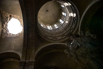 TOPSHOT - This picture taken on October 8, 2020 shows a hole in the roof of the Ghazanchetsots (Holy Saviour) Cathedral in the historic city of Shusha, some 15 kilometers from the disputed Nagorno-Karabakh province's capital Stepanakert, that was hit by a bomb as fighting between Armenian and Azerbaijani forces spilled over today ahead of a first meeting of international mediators in Geneva. - Nagorno-Karabakh broke away from Azerbaijan in a 1990s war that claimed the lives of some 30,000 people. The Armenian separatists declared independence, but no countries recognise its autonomy and it is still acknowledged by world leaders as part of Azerbaijan. (Photo by ARIS MESSINIS / AFP) (Photo by ARIS MESSINIS/AFP via Getty Images)