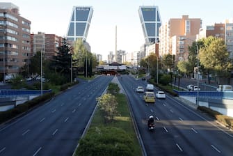 epa08723451 View of Castellana Avenue with very little traffic in downtown in Madrid, Spain, 06 October 2020. Madrid capital city and other 9 towns in the region have been 'closed' by the central Government to avoid mobility between those cities with high number of coronavirus cases amid a dispute between the central and regional Governments on how to lower down the epidemiological curve in the region. Madrid's regional Government filed a complaint at the Audiencia Nacional Court to avoid the closure of cities but restrictions have been carried out while the court rules out a decision on the matter.  EPA/J.J Guillen