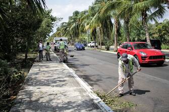 1279219237 CANCUN, MEXICO - OCTOBER 8: A member of the municipality cleaning staff clers debris from Hurricane Delta at Kukulkan Boulevard on October 8, 2020 in Cancun, Mexico. Hurricane Delta made landfall in the Mexican east coast in the morning of Wednesday October 07, between Cancún and Playa del Carmen, forcing evacuations in touristic areas. Governors of regions of Quintana Roo and Yucatán reported no deaths or major damage to the infrastructure. The powerful category 2 storm is expected to increase its power as it approaches the US Gulf coast. American National Hurricane Center informed Delta will move inland by late Friday 09. (Photo by Harold Alcocer/MediosyMedia/Getty Images)