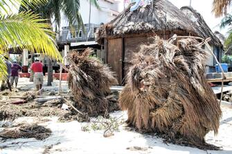 1279219249 CANCUN, MEXICO - OCTOBER 8: Wretched thatch umbrellas lie by a seaside resort destroyed by Hurricane Delta at 'Playa Tortuga' on October 8, 2020 in Cancun, Mexico. Hurricane Delta made landfall in the Mexican east coast in the morning of Wednesday October 07, between Cancún and Playa del Carmen, forcing evacuations in touristic areas. Governors of regions of Quintana Roo and Yucatán reported no deaths or major damage to the infrastructure. The powerful category 2 storm is expected to increase its power as it approaches the US Gulf coast. American National Hurricane Center informed Delta will move inland by late Friday 09. (Photo by Harold Alcocer/MediosyMedia/Getty Images)