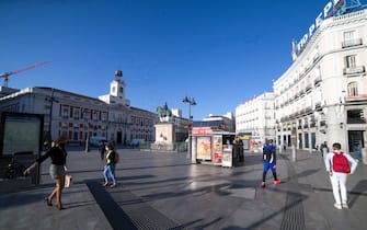 People transit during the day following the lifting of the confinement by court order at Puerta del Sol on October 9, 2020 in Madrid, Spain.