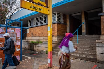 epa08731573 Pedestrians walk past the broken facade of the Jeppe Street railway station in the centre of  Johannesburg, South Africa, 06 October 2020 (issued 09 October 2020). The Jeppe Street station has effectively been stolen and all that is left is the brick shell of what was once a thriving metro station. Trains ran through the station as recently as 1 year ago.  Entire stations in the city have been stolen with only broken brick walls left behind as desperation forces unemployed ot steal the stations infrastructure. There have been a total of 1,833 incidents of vandalism at train stations in Gauteng over the past three years at a replacement cost in excess of R2-billion. Only 3 of the 17 railway lines in the countries biggest city are still running and its because of the ongoing stealing of mostly metal by 'metal scavengers who are desperate to make money as unemployment in South Africa reaches 50% due to a combination of years of economic downturns in the economy coupled with the huge negative effect of the strict Covid-19 Corona virus lockdown that has lasted 200 days already.  EPA/KIM LUDBROOK